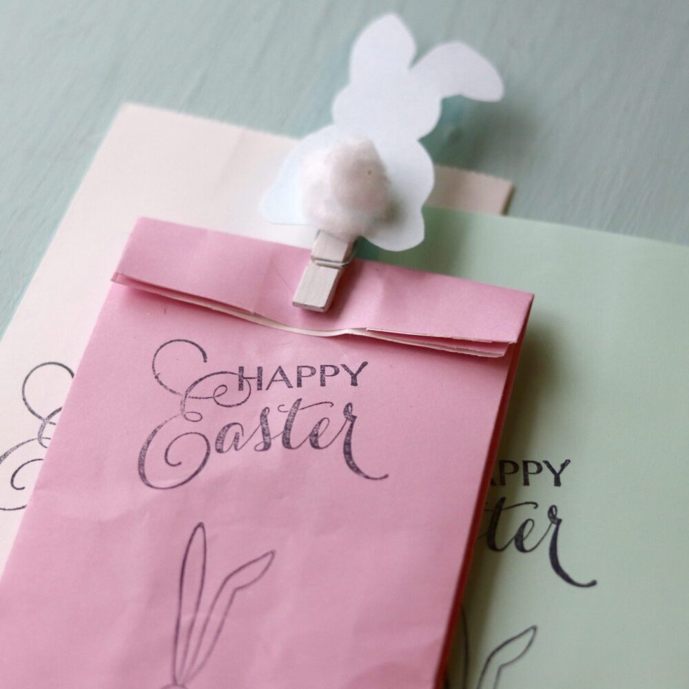 set of 3 Happy Easter Bags in 3 colors with bunny clip on teal background